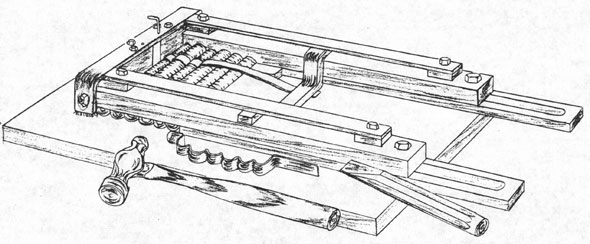 Strap forming jig with short pieces of cable in varius sizes in place.