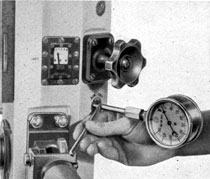 Figure 2-10. Insertion of 50 psi gage in outlet
connection and opening outlet valve.