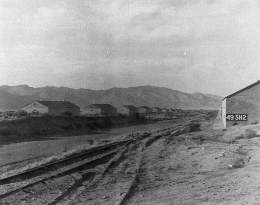 Row upon row of storage buildings in the foreground are framed by Nevada's Wassuc Mountains.