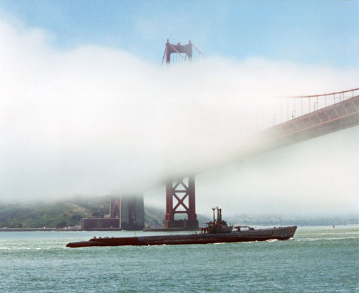 Photo of Pampanito being towed under the Golden Gate Bridge.
