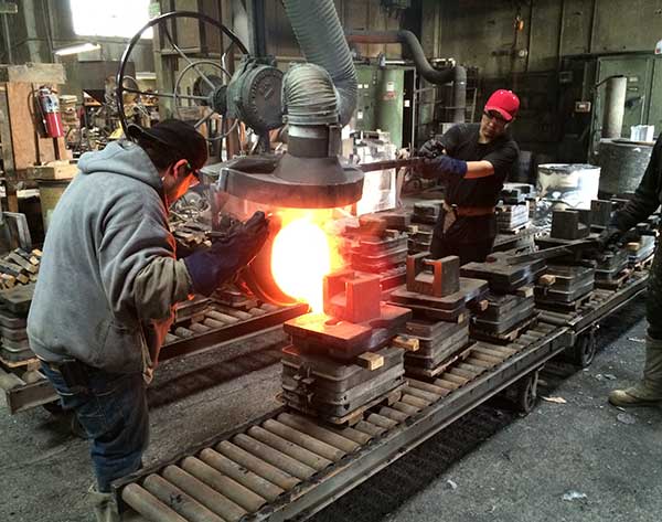 pouring molten bronze for handles boat.