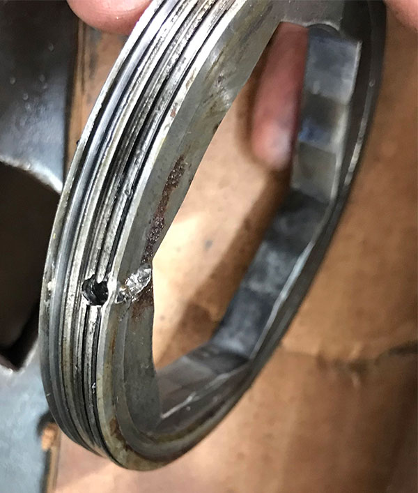 hole through threads of bearing retainer