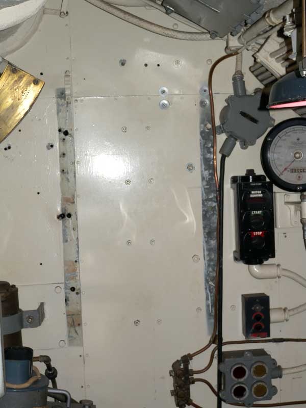 photo of bulkhead with holes and missing paint