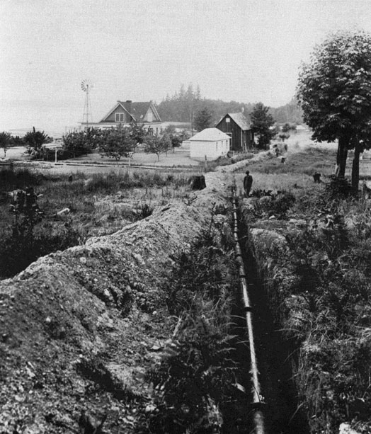 Photo showing an open trench with the water main.