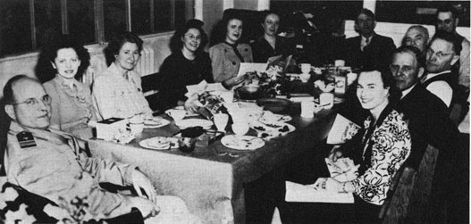 Public Works people gather for a dinner in 1945. Some familiar faces include, second from
left, Juanita Bloomquist, in the back at the end of the table, Herman Boldt, and sitting across
from Juanita, Agnes Carpinella. Next to her is Mr. Keyport himself, and head of Public Works,
Louie Strom.