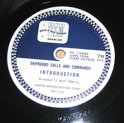 Photo of the first side of the first record.
USN BUREAU OF NAVAL PERSONEL TRAINING AIDS
NP11334RA
USN 1594
START OUTSIDE
78 RPM

SHIPBOARD CALLS AND COMMANDS

INTRODUCTION
Recorded 11 May 1950 by
EMPIRE BROADCASTING CORP.
New York